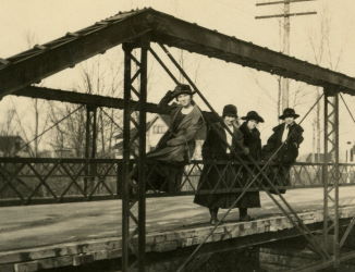 People posing with bridges